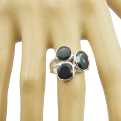 Florencia black gemstone trilogy ring with three faceted black stones on silver band worn on hand