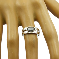 Natcha black solitaire ring for women with silver band on mannequin finger