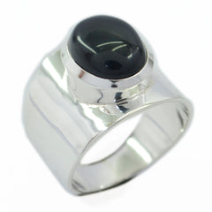 Dewi black solitaire ring for women with a polished silver band and oval black stone centerpiece