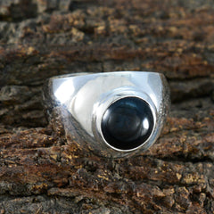 Araya polished sterling silver ring with round black cabochon stone black solitaire ring displayed on bark