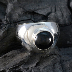 Araya polished silver ring with round black cabochon center on a wide band black solitaire ring