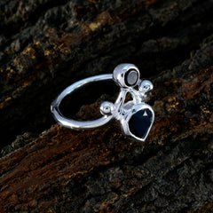 Sarah silver black toi et moi ring with pear and round black gemstones on polished band on bark background
