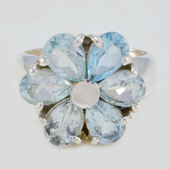 Lucia blue floral gemstone ring featuring pear-shaped blue stones arranged in a flower design