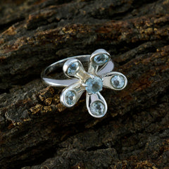 Claire blue floral gemstone ring with silver band and light blue stones shaped like flower petals