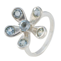 Claire blue floral gemstone ring with silver band and multiple light blue stones in floral design