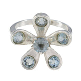 Claire blue floral gemstone ring with silver band and light blue stones arranged in flower shape