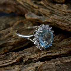 Violet silver halo blue topaz blue gemstone fashion ring with diamond accents on rustic wood backdrop