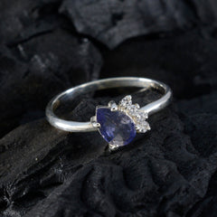 Min-seo elegant blue gemstone halo ring with a pear-shaped blue stone and small surrounding diamonds