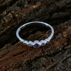 Ying sterling silver ring with five bezel set stones centered by a blue gemstone ring for women on rustic bark