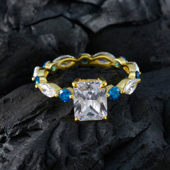Carla gold ring with large emerald cut center stone and blue accent gems on band blue gemstone ring for women