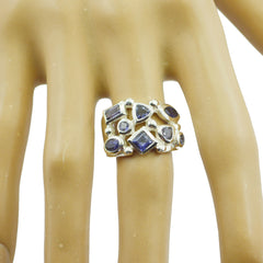 Camila blue gemstone ring with multiple blue stones set in silver band on display hand