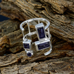 Bella silver open band blue gemstone signet ring with rectangular and round indigo stones on rustic wood