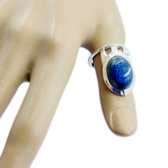 Maria blue gemstone solitaire ring with oval stone set in silver band on mannequin finger