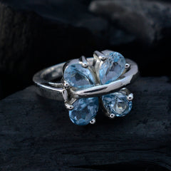 Laura silver ring with four pear shaped blue stones forming a floral cluster blue gemstone statement ring