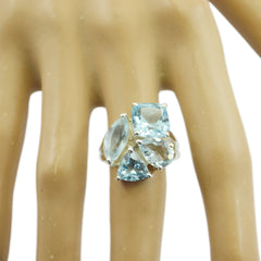 Lucia silver cluster blue gemstone statement ring with mixed cuts on a mannequin hand display