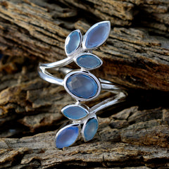 Sofia silver blue gemstone statement ring with multiple oval and marquise blue stones on rustic wood background