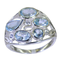 Julieta blue gemstone statement ring with multiple oval and round blue stones in silver setting
