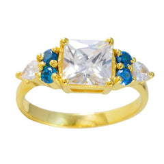 Jia gold ring featuring a blue gemstone statement ring design with a large clear center stone and blue accents
