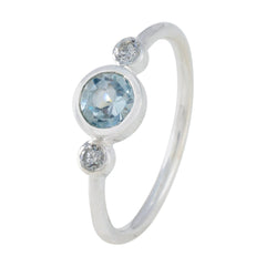 Nari silver ring featuring a blue gemstone trilogy ring design with one large blue stone and two smaller clear stones