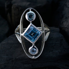 Leah blue gemstone trilogy ring with a square center stone and two round side stones in silver setting
