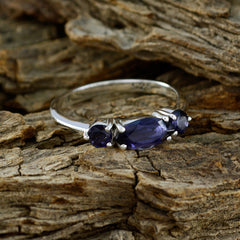 Eunji silver blue gemstone trilogy ring with marquise center and round side stones on rustic wood