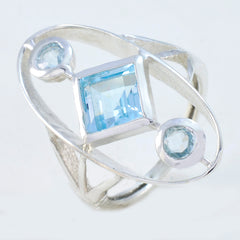 Leah blue gemstone trilogy ring with square and round blue stones set in silver band