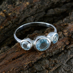 Natcha silver blue gemstone trilogy ring with three bezel set aquamarine stones on silver band