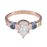 Sofia rose gold ring with pear shaped clear center stone and round blue side stones blue gemstone wedding ring