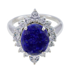 Maria blue halo gemstone ring with deep oval blue center stone and sparkling diamond halo on silver band