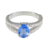 Teresa blue halo gemstone ring with oval blue center stone and double diamond band