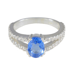 Teresa blue halo gemstone ring with oval blue center stone and double diamond band