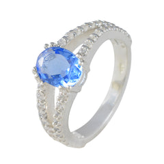 Teresa blue halo gemstone ring with a large oval blue stone and sparkling accent diamonds