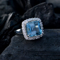 Lourdes blue halo ring for women with square blue topaz center and diamond halo on sterling silver band