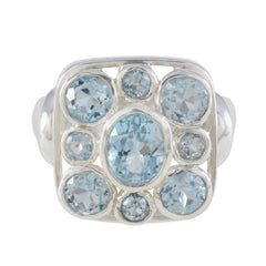 Josephine blue navratna ring sterling silver with central oval aquamarine and eight round pale blue gemstones