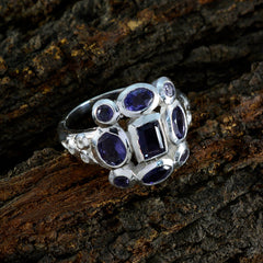 Emma blue navratna ring sterling silver multi stone ring with oval and square blue gemstones on textured background