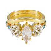Ella gold ring with intricate design featuring a central marquise gemstone and blue penta gemstone ring accents