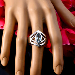 Autumn blue solitaire art deco ring with marquise blue gemstone on silver band displayed on hand