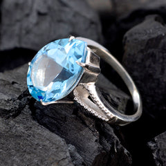 Paula blue solitaire gemstone ring with large faceted blue stone set on silver band