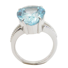Paula blue solitaire gemstone ring with large faceted blue stone and silver band detailing