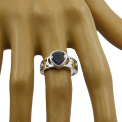 Maria blue solitaire heart ring with silver band on display hand