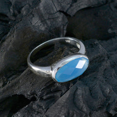 Wen sterling silver ring with faceted oval blue gemstone blue solitaire ring for women on dark textured stone