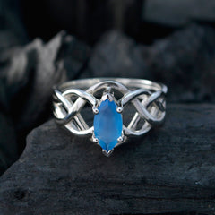 Carla elegant blue solitaire ring for women with a marquise-cut blue gemstone and intricate silver band design