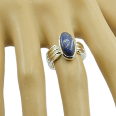 Natalie blue solitaire ring with oval blue stone set in silver band on a hand model