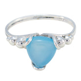 Clara blue solitaire ring with a polished silver band and a smooth triangular blue gemstone