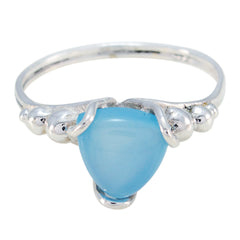Clara blue solitaire ring with a polished silver band and a smooth triangular blue gemstone
