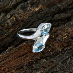 Claire sterling silver ring with two marquise blue gemstones blue toi et moi ring on wood