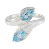 Claire sterling silver ring with two pear shaped blue gemstones in a wrap style blue toi et moi ring