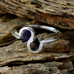 Meera elegant silver blue toi et moi ring with two pear-shaped blue gemstones on rustic wood
