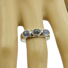Emi silver band with three round cabochon stones on a display finger blue trilogy gemstone ring