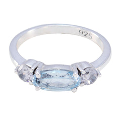 Emi silver blue trilogy gemstone ring with oval blue center stone and two clear side stones